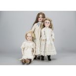 Three German bisque headed child dolls, an Armand Marseille 390 —21in. (53.5cm.) high, another