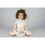 A Schoenau & Hoffmeister 169 character baby, with blue lashed sleeping eyes, brown mohair wig,