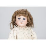 A German child doll marked C, with blue sleeping eyes, brown mohair wig, jointed composition body,