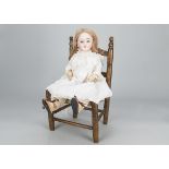 A Max Handwerck 283 child doll, with blue sleeping eyes, replaced blonde wig, jointed composition