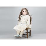 An Armand Marseille 390 child doll, with brown sleeping eyes, blonde hair wig, jointed composition