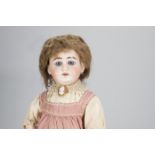 An Armand Marseille 1897 child doll, with blue striated eyes, heavy glazed brows, brown mohair