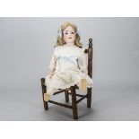 An Ernst Heubach 302 child doll, with blue sleeping eyes, blonde hair wig, jointed composition body,