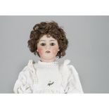 A Simon & Halbig 1079 child doll, with brown sleeping eyes, pierced ears, brown nylon wig, jointed