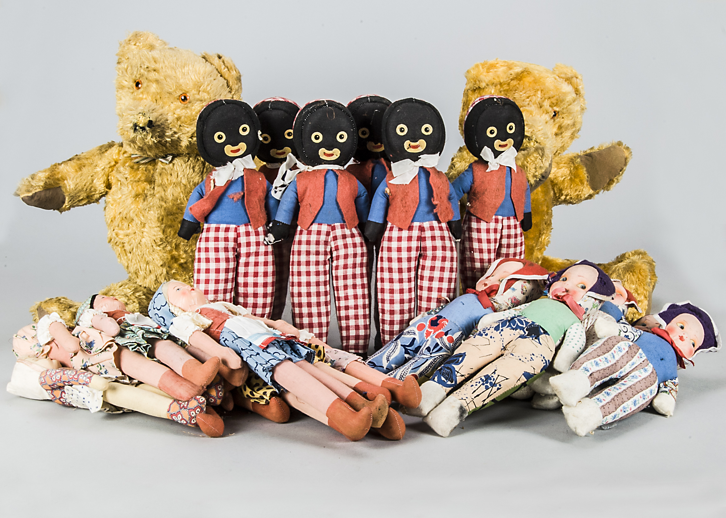 Cloth dolls and teddy bears, six Golliwoggs with gingham trousers —13½in. (34cm.) high, seven