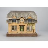 A German small dolls’ house thatched cottage, cream painted with stencil stone effect, textured