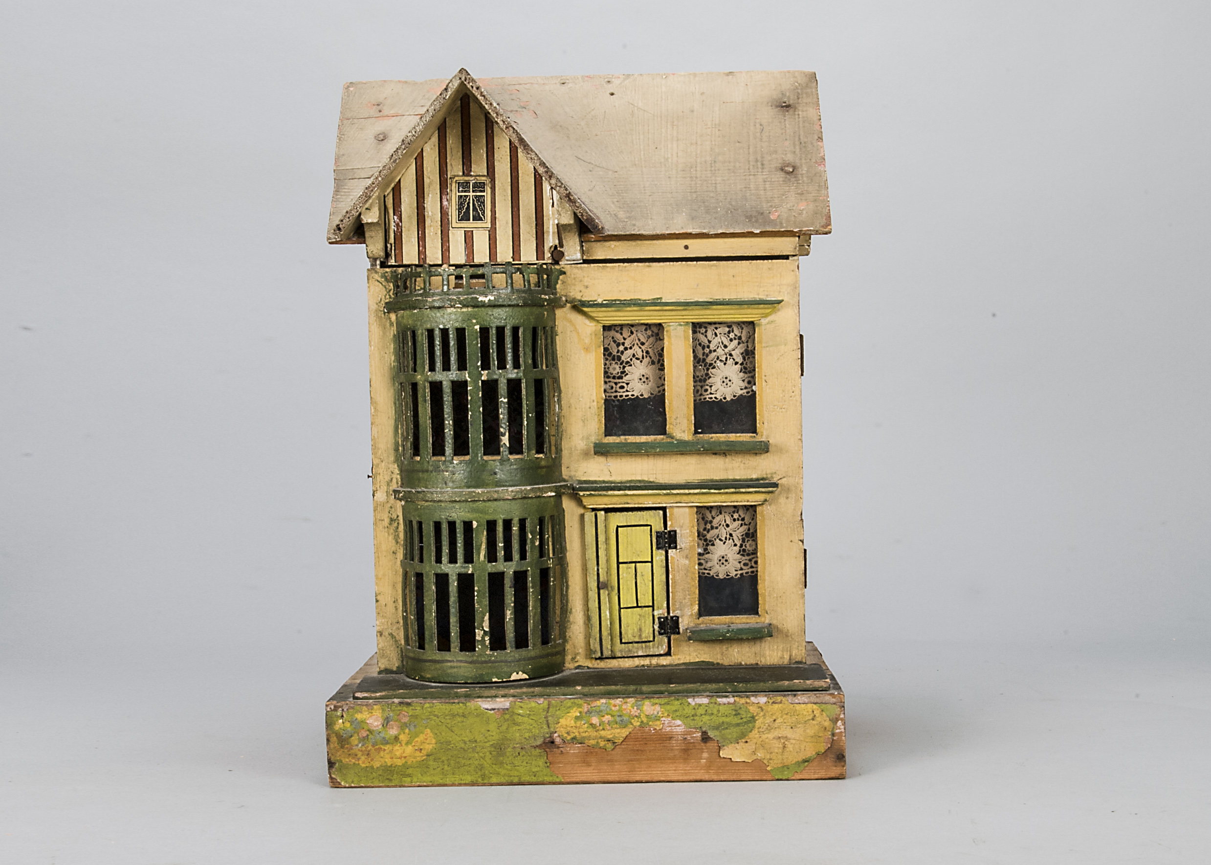 A German small wooden dolls’ house, cream, green and yellow painted with two storey usual full