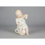 An unusual Gebruder Heubach baby seated on chamber pot, in nightshirt with sad face, unusual jointed