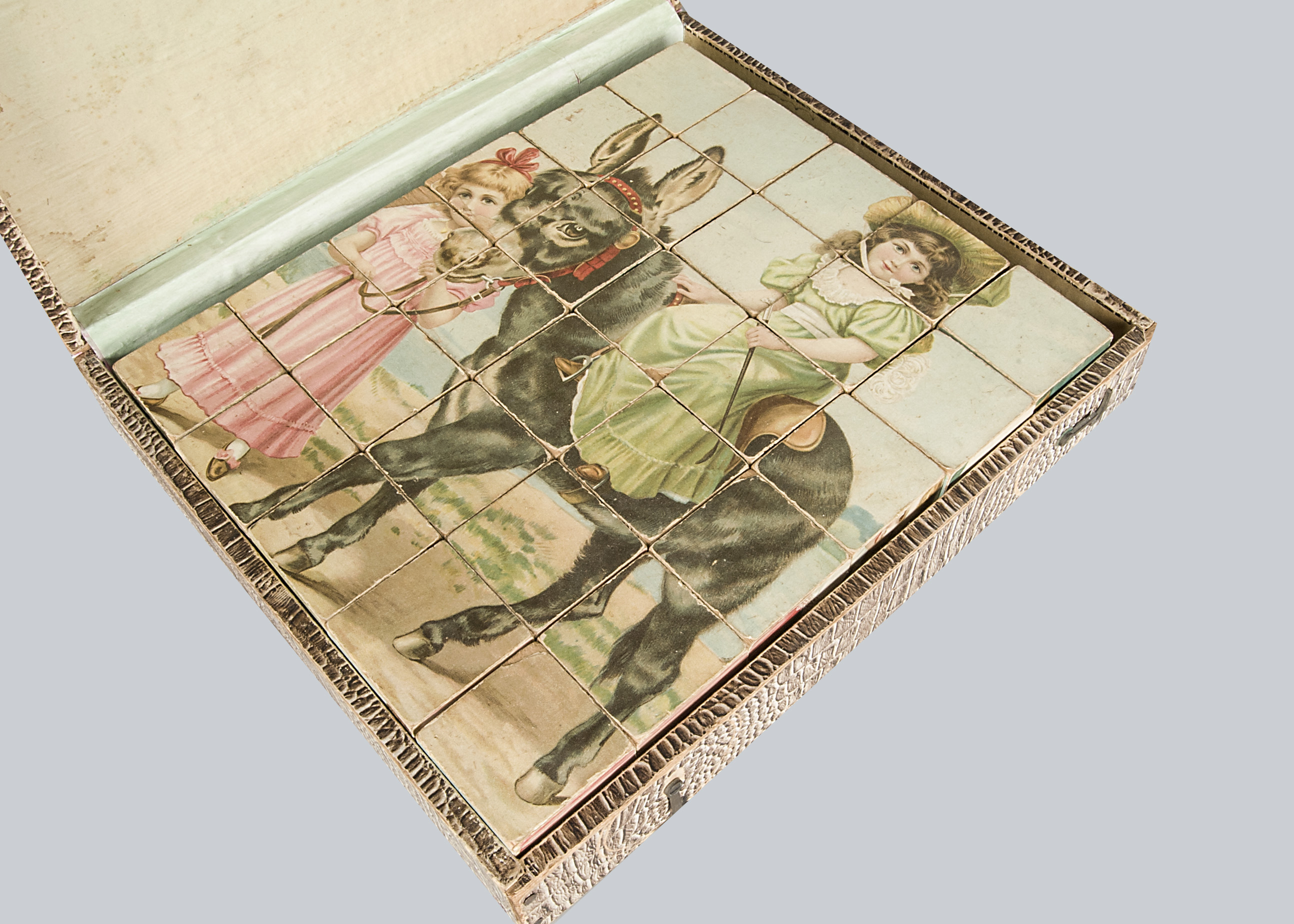 A large picture block puzzle, with scene of two girls riding a seaside donkey, in original box circa