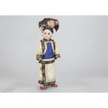 A German bisque headed child doll in traditional Chinese dress, with fixed dark eyes, elaborately