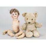 A Schutzmeister & Quendt 201 character baby, with blue sleeping eyes, brown mohair wig and bent-