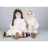 Two German bisque headed dolls, an Ernst Heubach 1900 on jointed composition body —25in. (63.5cm.)