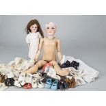 Dolls and dolls’ shoes, an Armand Marseille 390 with brown hair wig, jointed composition body and