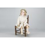 A large Armand Marseille child doll, with brown sleeping eyes, blonde hair wig, jointed