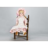 An Armand Marseille 390 child doll, with blue sleeping eyes, modern blonde hair wig, jointed
