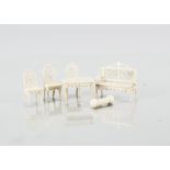 Small scale bone dolls’ house furniture, a sofa with intricate pierced back and seat —2in. (5cm.)