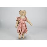 A rare Cobo of Guernsey painted stockinette doll, with primitive stitched raised nose and brown,