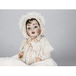 A Konig & Wernicke 99 character baby, with blue sleeping eyes, replaced brown wig, bent-limbed