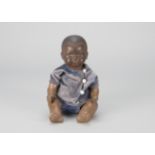 An Armand Marseille 341 black baby, with brown sleeping eyes, closed mouth, black painted hair,