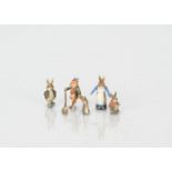 Four miniature cold painted bronze Beatrix Potter characters, Mrs Rabbit -1in. (2.5cm.) high,