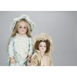 Two German bisque headed child dolls, a doll marked B4 with brown lashed sleeping eyes,