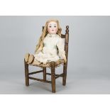 A large Cuno & Otto Dressel child doll, with brown lashed sleeping eyes, brown hair wig, jointed