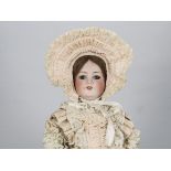 An Armand Marseille 390 child doll, with lashed blue sleeping eyes, brown wig, jointed composition