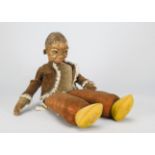 A large Norah Wellings black doll, with brown glass side glancing eyes, velvet Dutch style