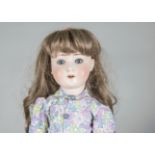 A Schoenau & Hoffmeister 1909 child doll, with blue sleeping eyes, replaced brown wig, jointed