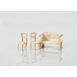 Small scale bone dolls’ house furniture, a sofa with intricate pierced back and seat —2½in. (6.5cm.)