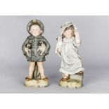 A pair of German bisque figures of children with dogs, the boy dressed in grey sailor’s suit holding