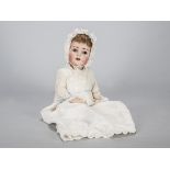 A Franz Schmidt & Co 1295 character baby, with brown sleeping eyes, light brown mohair wig,