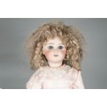 A SFBJ 301 child doll, with blue sleeping eyes, replacement blonde curly wig, jointed composition