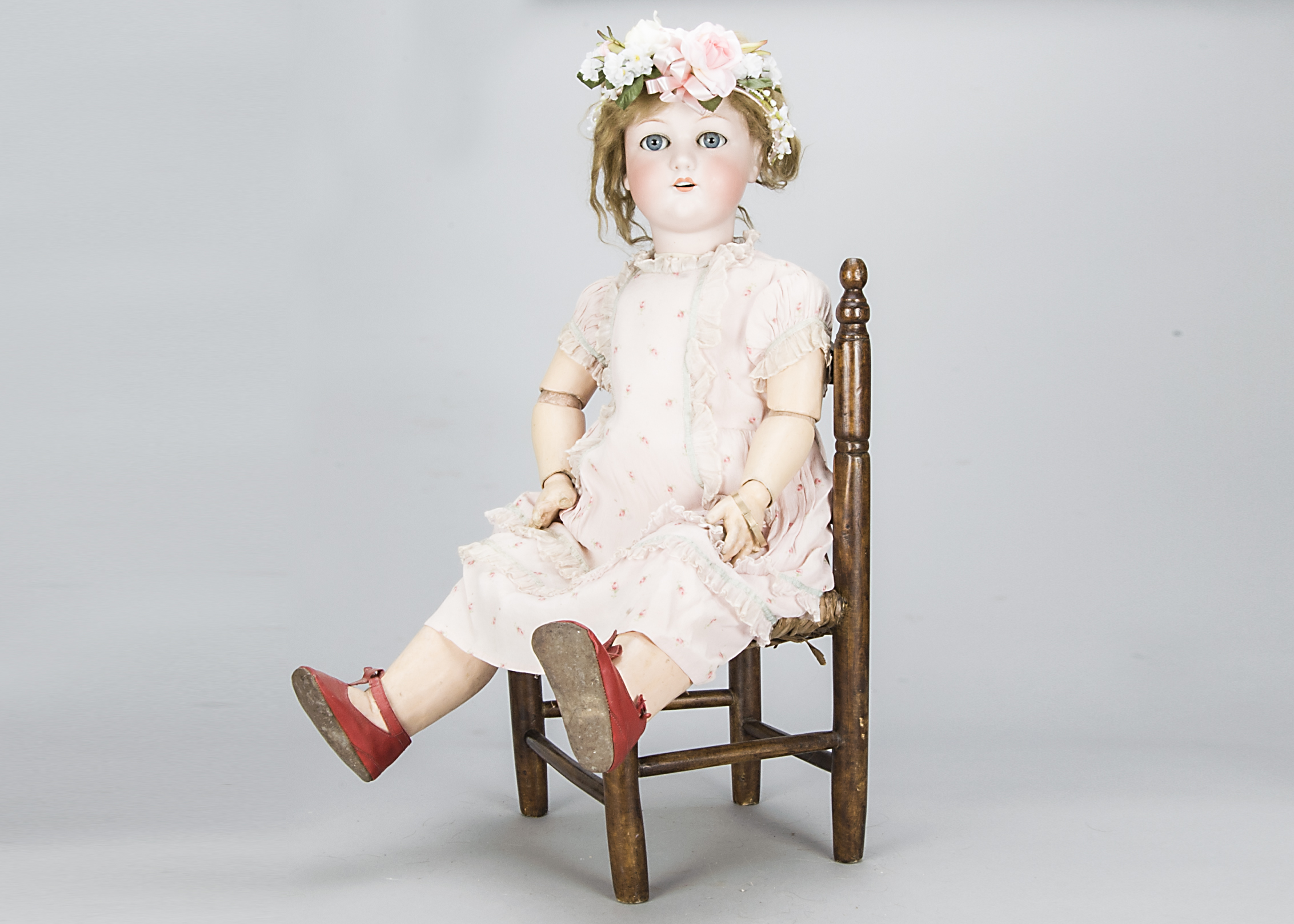 A Schoenau & Hoffmeister 1909 child doll, with blue sleeping eyes, blonde hair wig, jointed