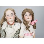 Two large German bisque headed child dolls, an AM 390 and an Ernst Heubach 302, both with blue