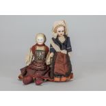 A German bisque shoulder head doll in regional costume, with mould blonde hair held in an Alice