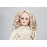 A SFBJ child doll, with dark sleeping eyes, pierced ears, blonde mohair wig, jointed wooden and