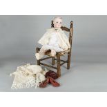 A Schoenau & Hoffmeister 1909 child doll, with blue sleeping eyes and jointed composition body —