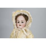 A Simon & Halbig 1039 child doll, with brown lashed flirty eyes, pierced ears, brown mohair wig,