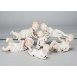 Six German bisque babies, one reclining sucking thumb —8in. (20cm.) long, one seated with a milk