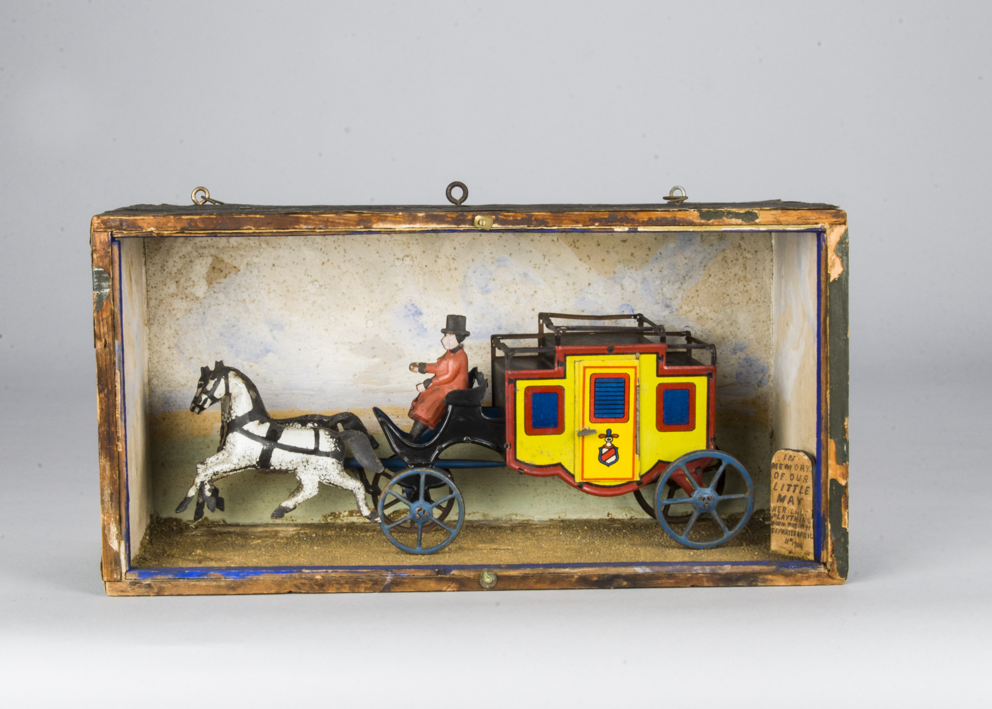 A German lithographed and painted tinplate mail coach, with yellow, red and blue carriage, two