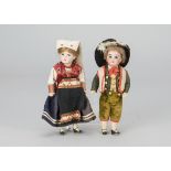 A Gerbruder Kuhnlenz boy and girl doll, with fixed dark eyes, the girl with light brown wig, the boy