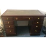 A mahogany veneered twin pedestal desk, moulded top with a green leather insert with gold tooling,