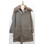 A 1999 Tillverkare Swedish (manufacturer's stamp) grey canvas coat, with sheepskin lining, displayed