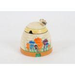 A Clarice Cliff for Royal Staffordshire honeypot, of beehive form, in the 'crocus' pattern, with bee