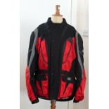 A 1990's IXS of Switzerland motorcycle suit, in black and red lumidex, comprising of a jacket with a