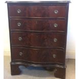 An early 20th Century Chippendale style mahogany serpentine front chest of drawers, with shaped