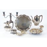A large quantity of silver plated items, including teapots and coffee pots with engraved decoration,