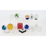 A quantity of glass paperweights, including one in the form of a globe, a knotted heart, a House