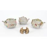 Three Japanese bisque teapots, each with relief moulded decoration of flora and fauna with